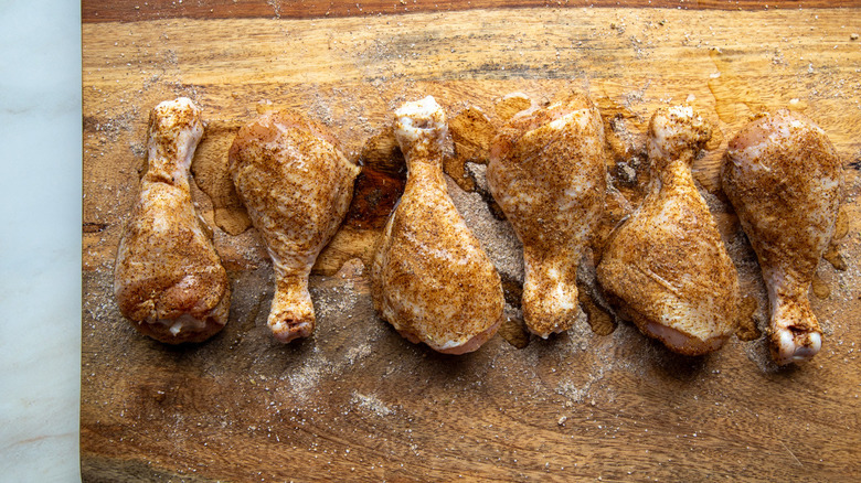 oil drizzled on spiced drumsticks