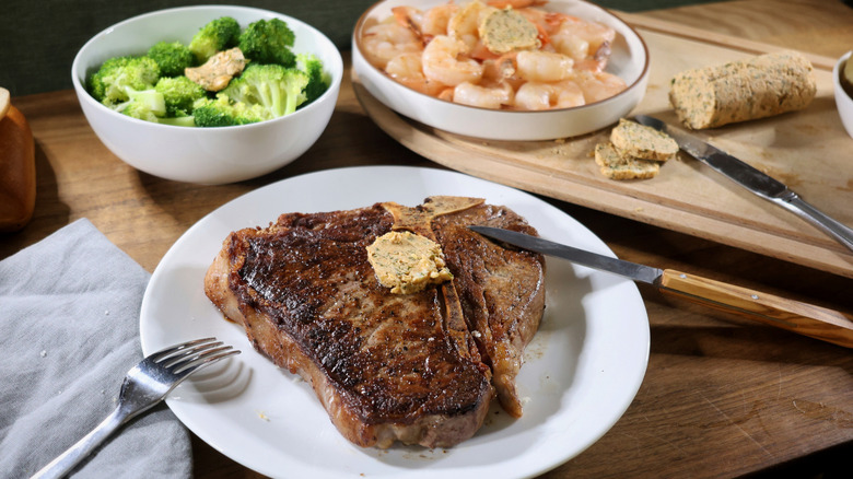 Cowboy butter on T-bone steak, shrimp, and broccoli