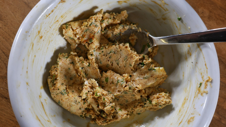 Bowl of mashed cowboy butter with metal spoon