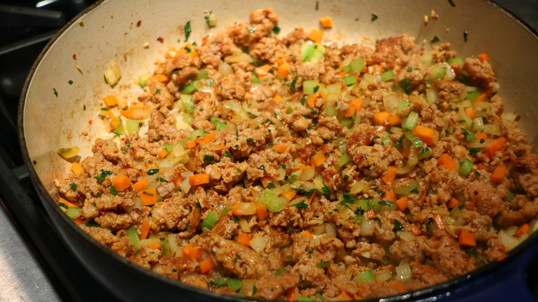 skillet of sausage, celery, carrot, onion, and garlic