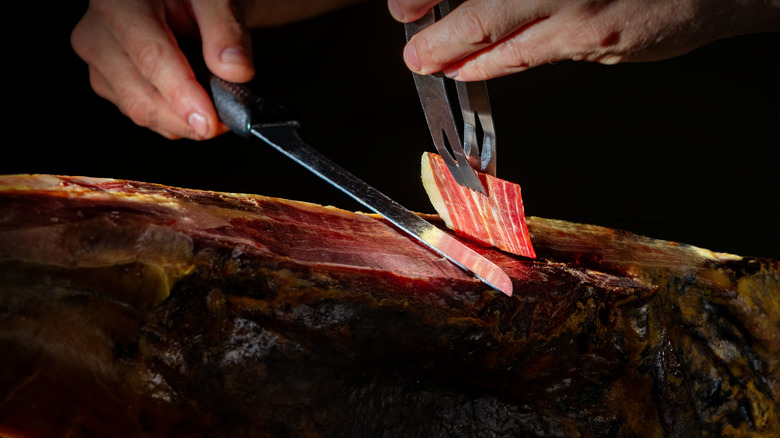 Slicing jamon with knife