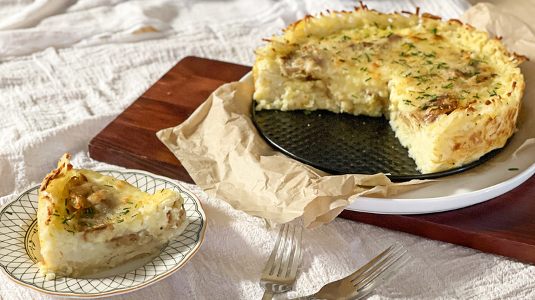 Spanish tortilla-inspired quiche with hash brown crust with slice