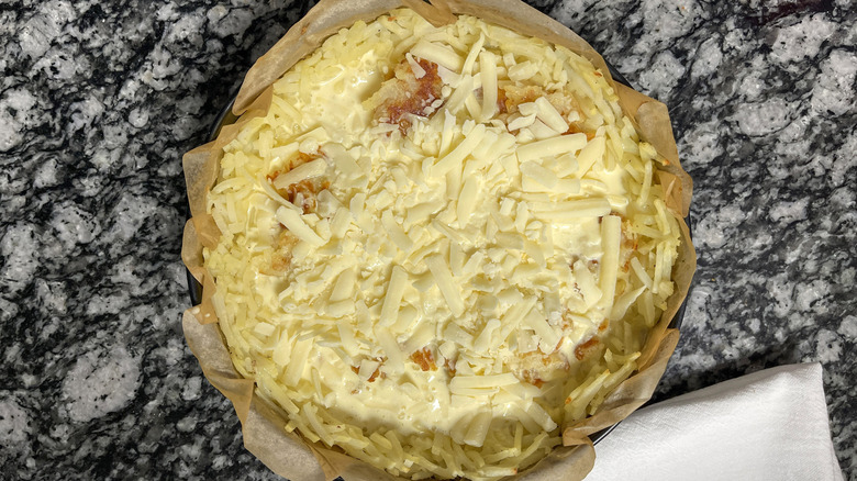 egg mixture and cheese over hash brown crust