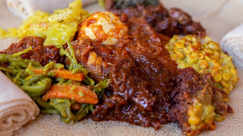 doro wat and vegetables on injera