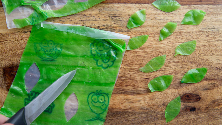 green Fruit Roll-ups being cut