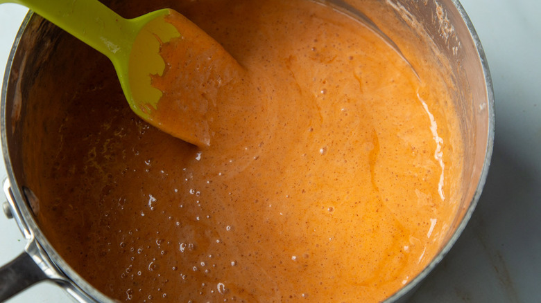 orange bubbly liquid in pot