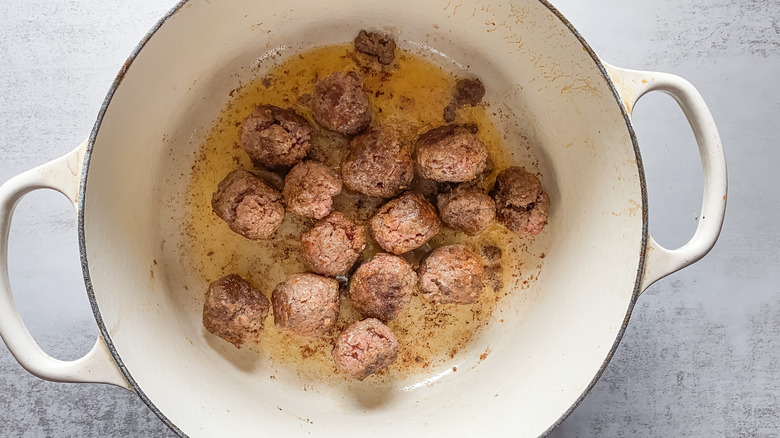 meatballs searing in pan