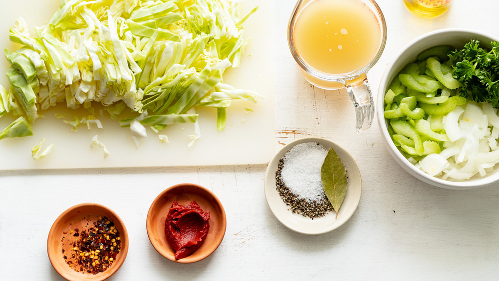 Ingredients needed for cabbage soup out on a table