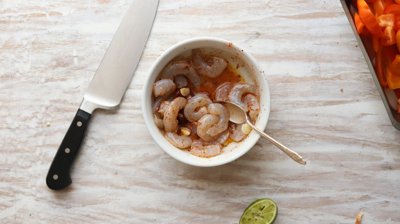 raw shrimp in reddish liquid