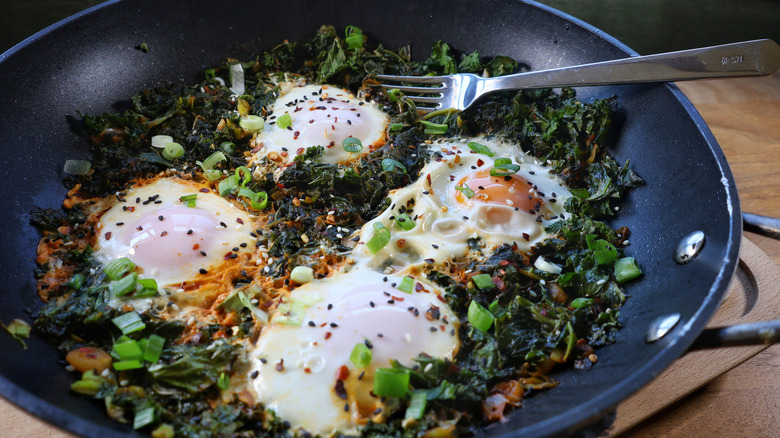 skillet of gochujang kale and eggs