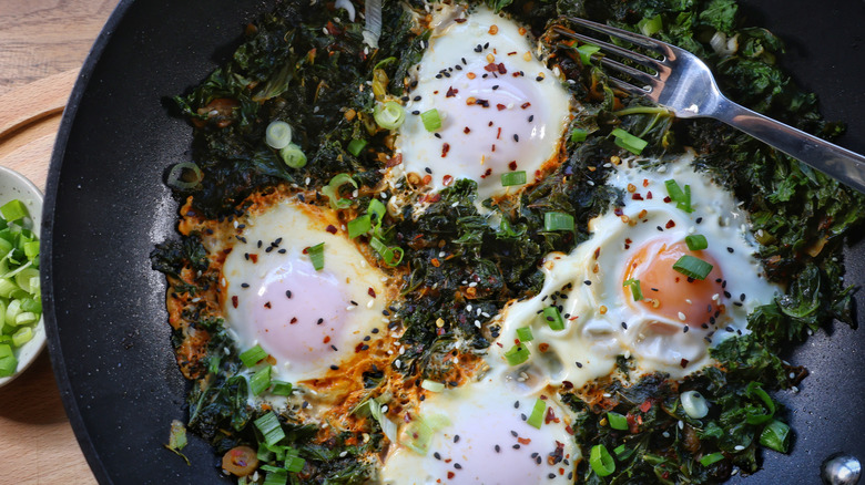 skillet of gochujang kale and eggs