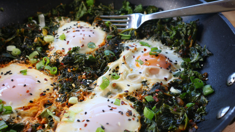 skillet of gochujang kale and eggs