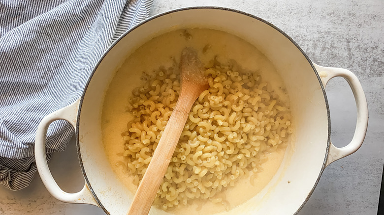 Photo of pasta being mixed into cheese sauce