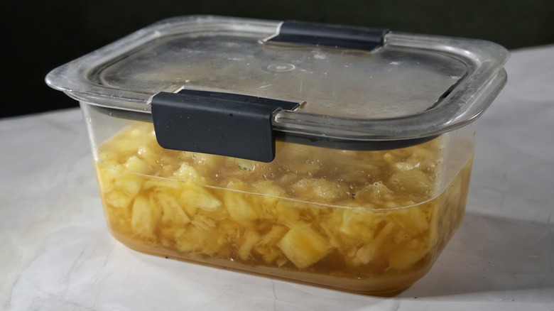 container of pineapple shrub syrup