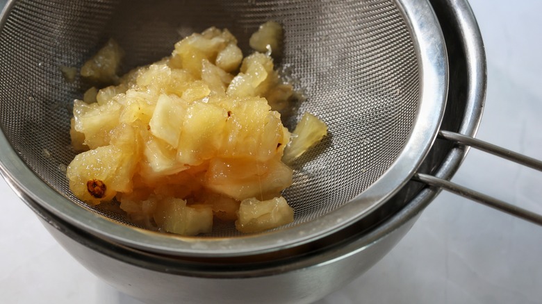 sieve full of pineapple