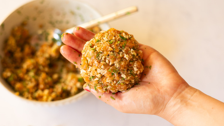 hand shaping salmon burger patty