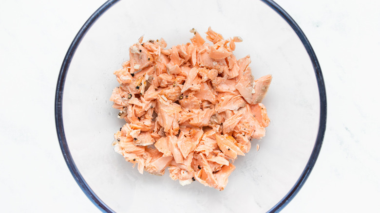 Flaked salmon in mixing bowl