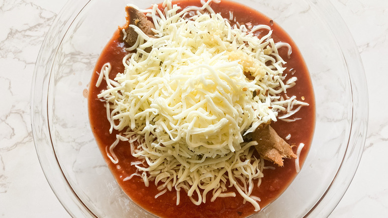 Sauce, 'nduja sausage, and cheese in a bowl