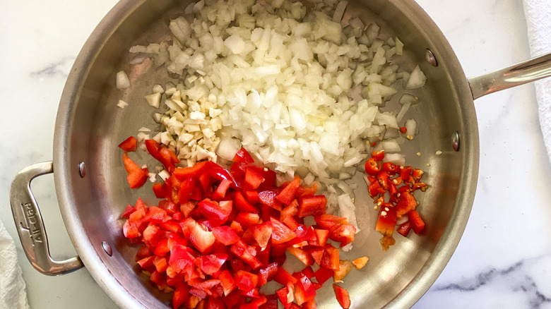 cooking onions, garlic, red pepper, and chilis