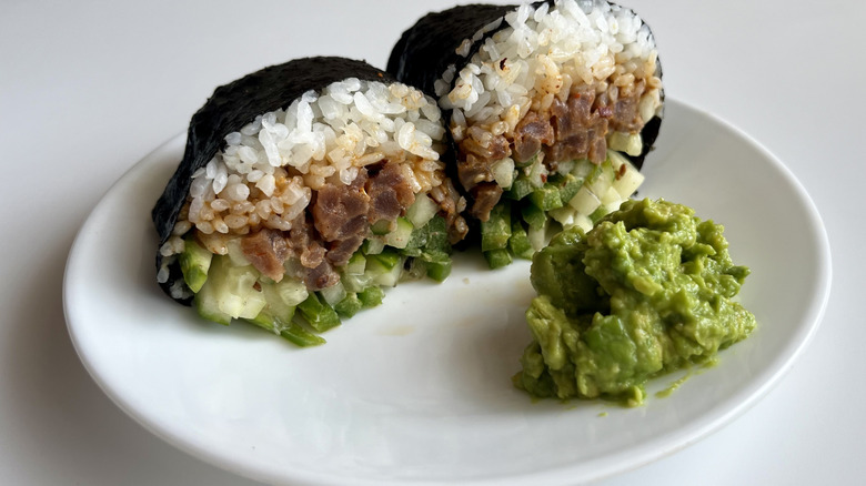 halved sushi burrito with wasabi guacamole