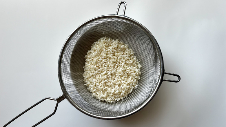 rice in mesh strainer