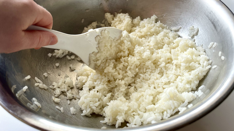 paddle stirring rice in bowl