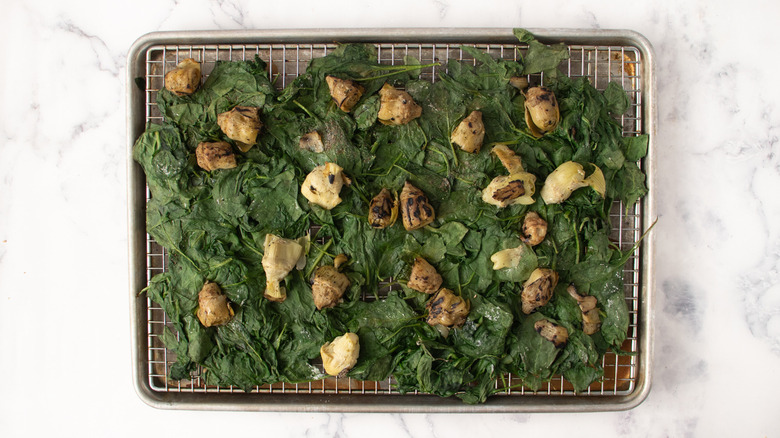 Spinach and artichokes on wire rack