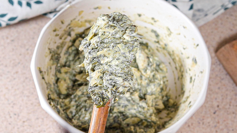 spinach artichoke filling on spatula