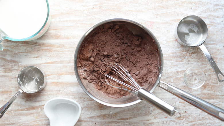 pudding ingredients in bowl with whisk