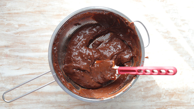 chocolate pudding in sieve