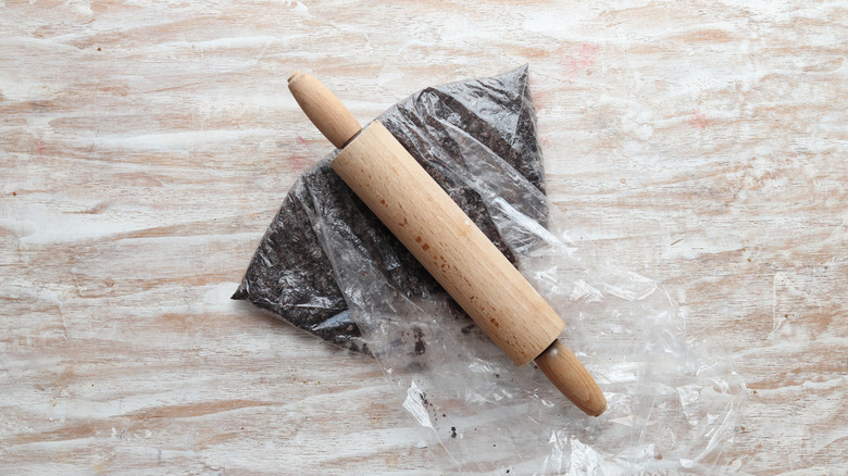 rolling pin on bag of crushed cookies