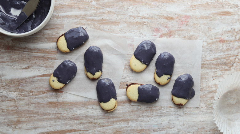 frosted Milano cookies on parchment paper