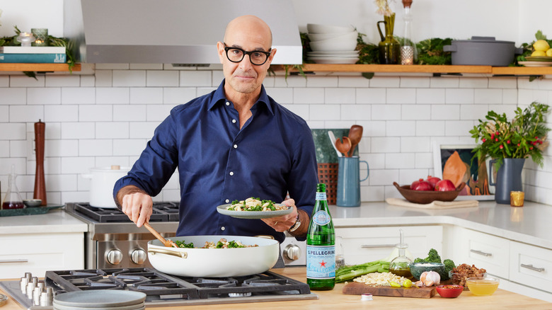 stanley tucci in kitchen cooking pasta