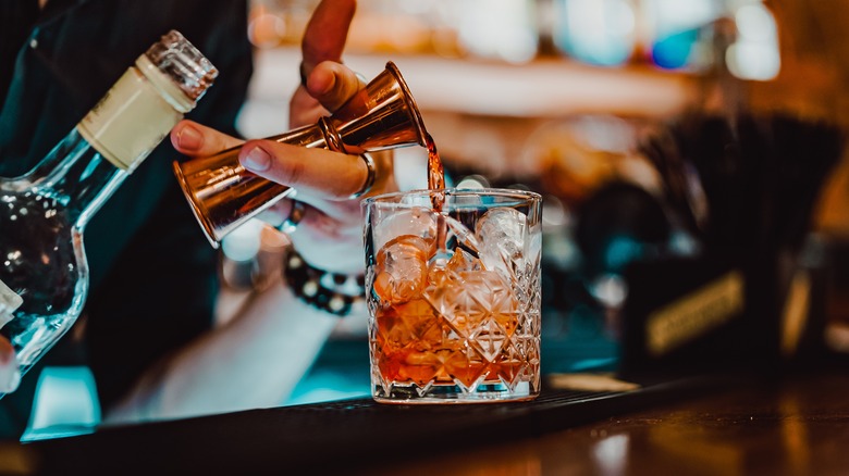 Bartender pours a negroni