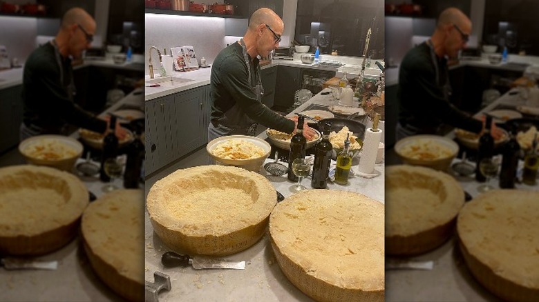 Stanley Tucci with cheese wheel