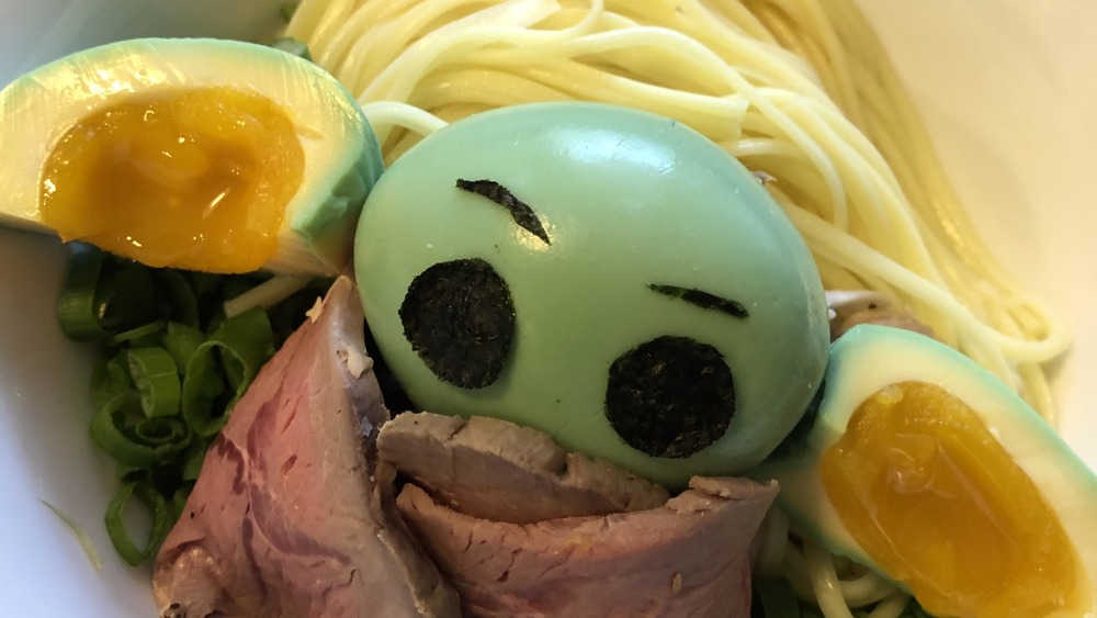 Baby Yoda make from green egg, ears have yolks, coat made from beef, in a bowl of noodles