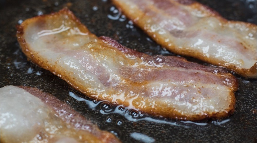 Bacon frying in a pan for Starbucks Bacon, Sausage & Egg Wrap copycat recipe