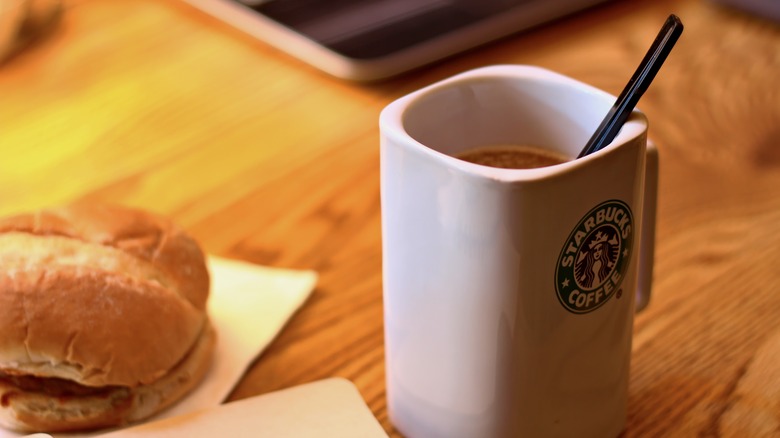 A Starbucks mug containing coffee