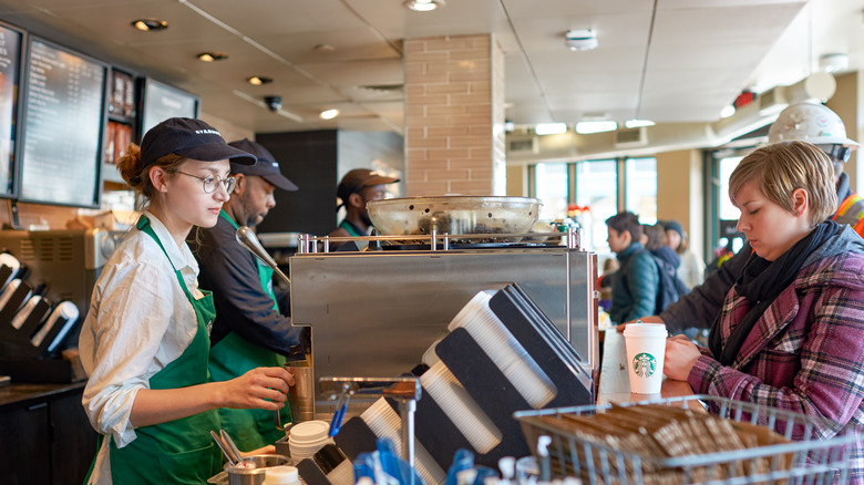 Starbucks barista standing across from customer 