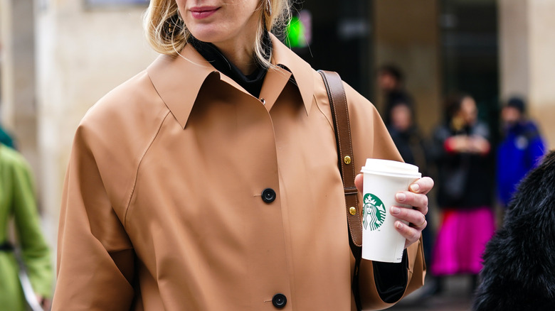 Starbucks cup in women's hand