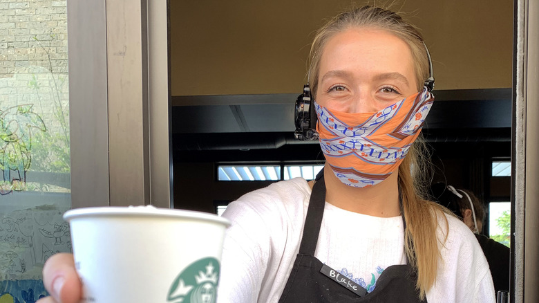 starbucks employee works drive-thru