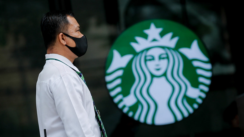 Masked person and Starbucks sign