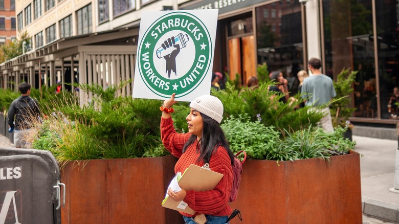 Starbucks protestor holding sign