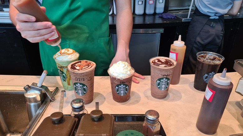 Starbucks barista making customized iced drinks