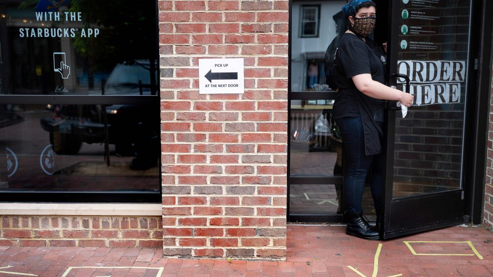 starbucks employee with mask at door