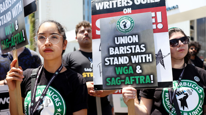 Starbucks protesters holding signs