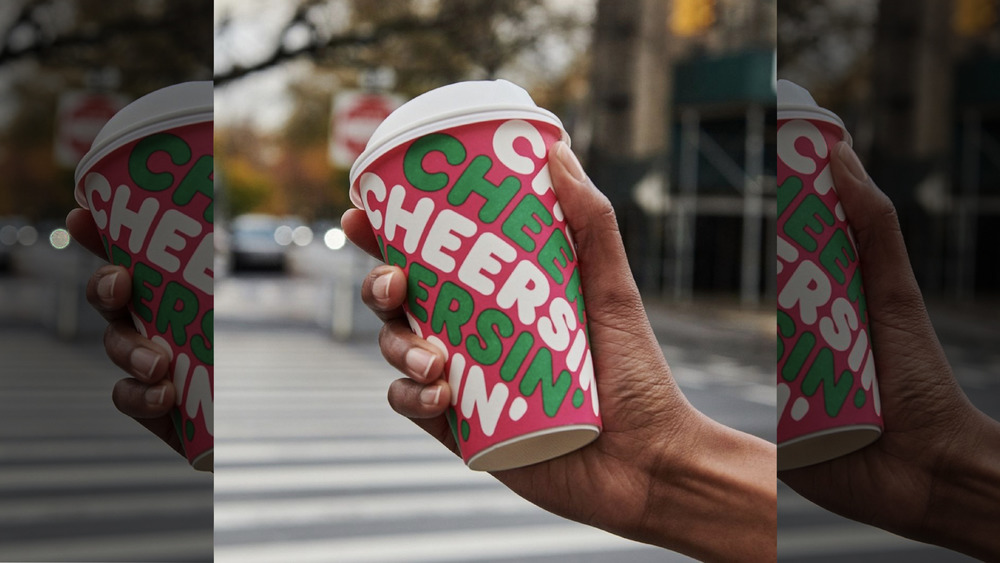 hand holding Dunkin' coffee