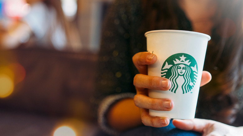 Girl holding starbucks cup 