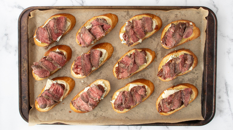 steak blue cheese crostini on baking sheet