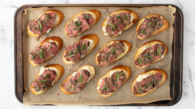 steak blue cheese crostini on baking sheet